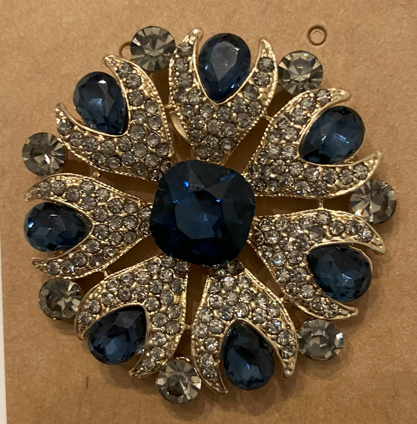 Vintage brooch with dark blue gemstones