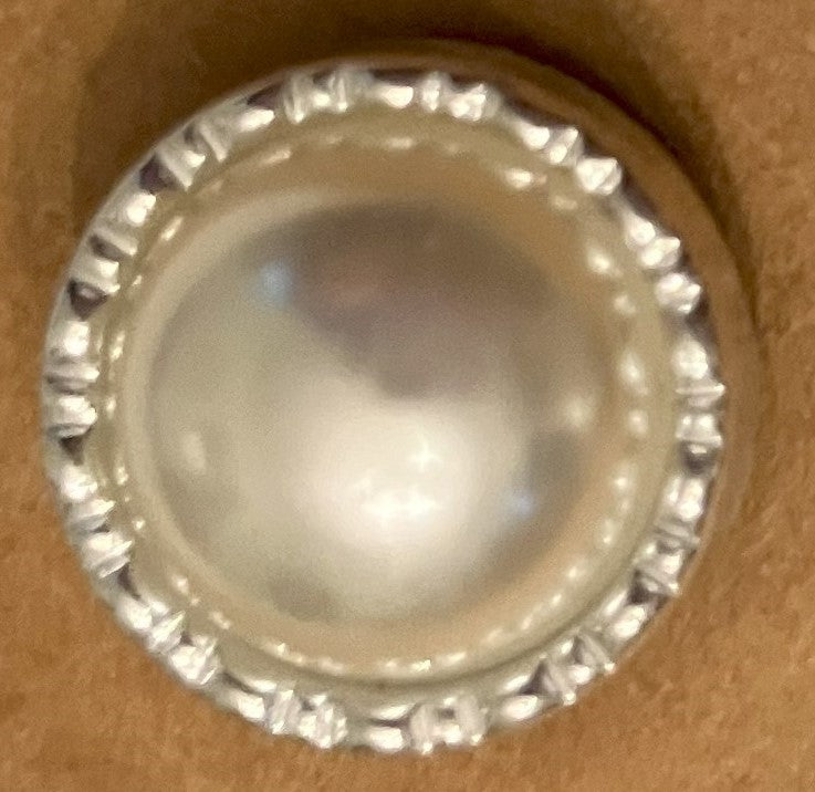 Pearl earrings surrounded by clear stones