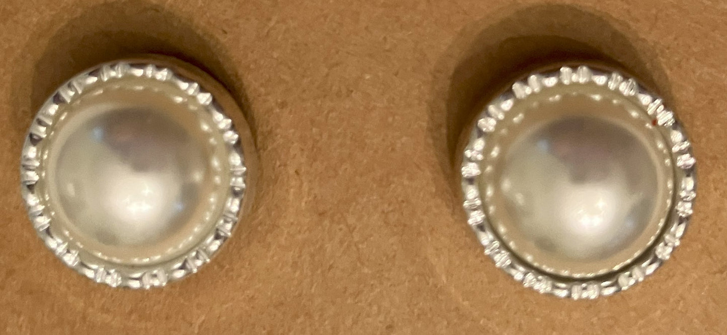 Pearl earrings surrounded by clear stones