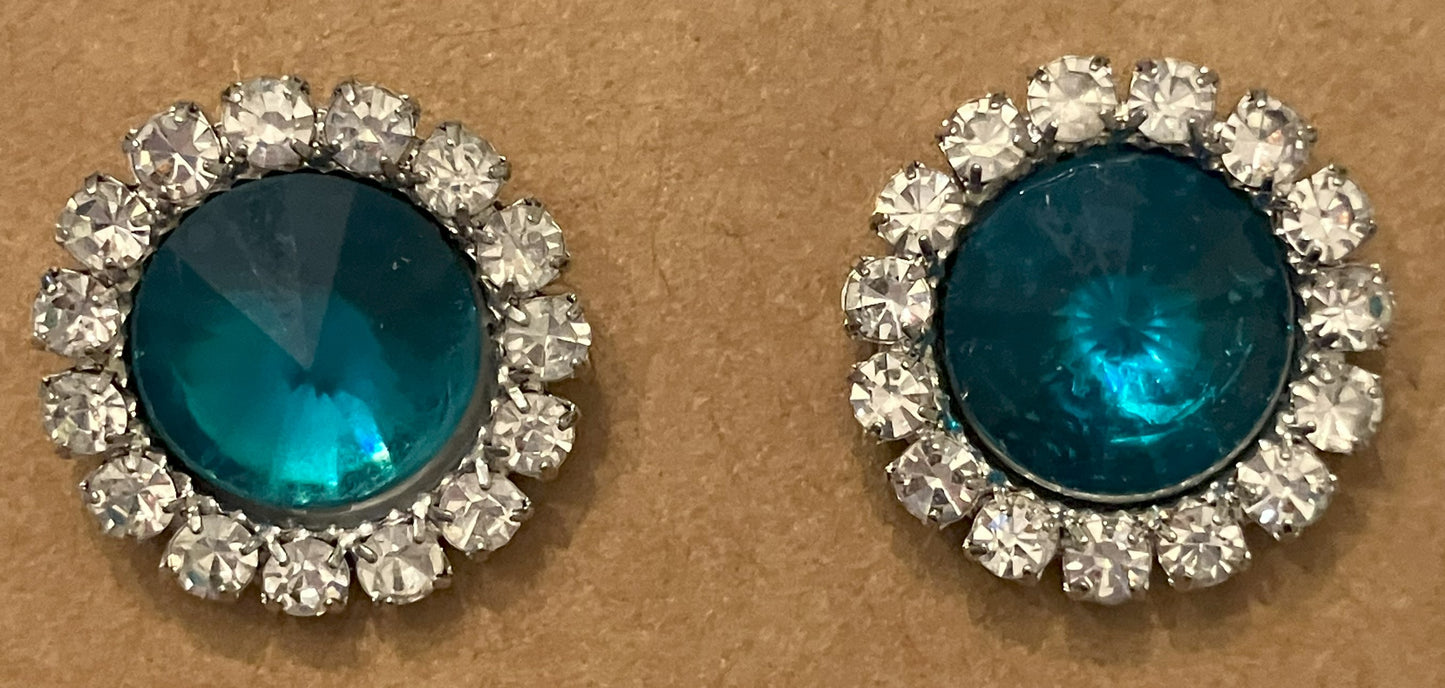 Pair of round, teal-colored central gemstone earrings with halos