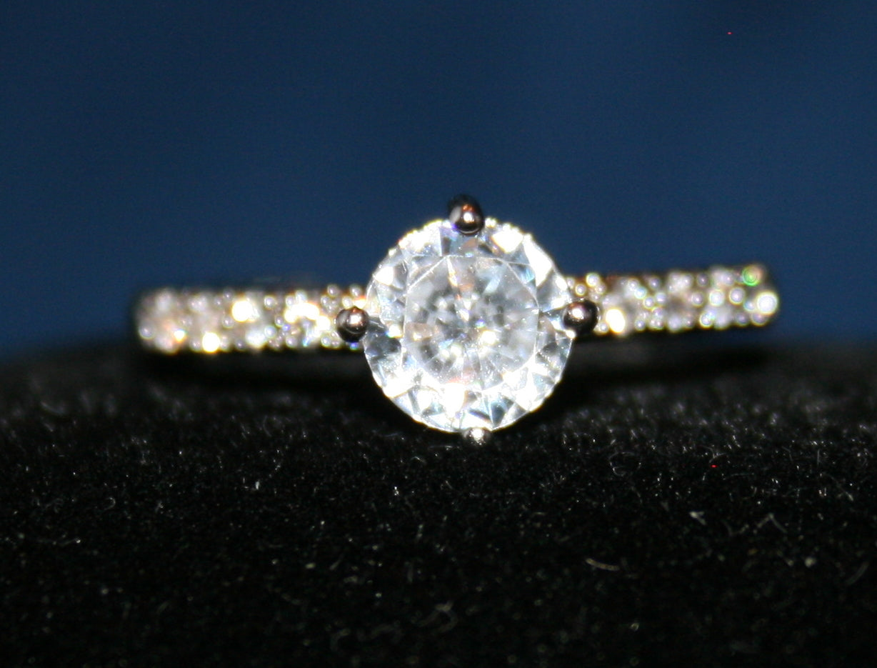 Adjustable single solitaire with white stones on the band.