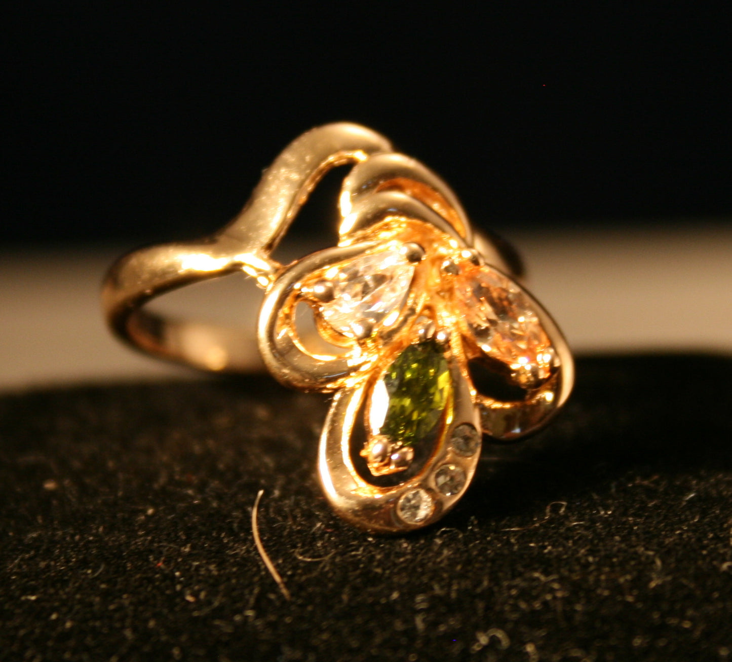 flower design with green, yellow circle and brown gemstones