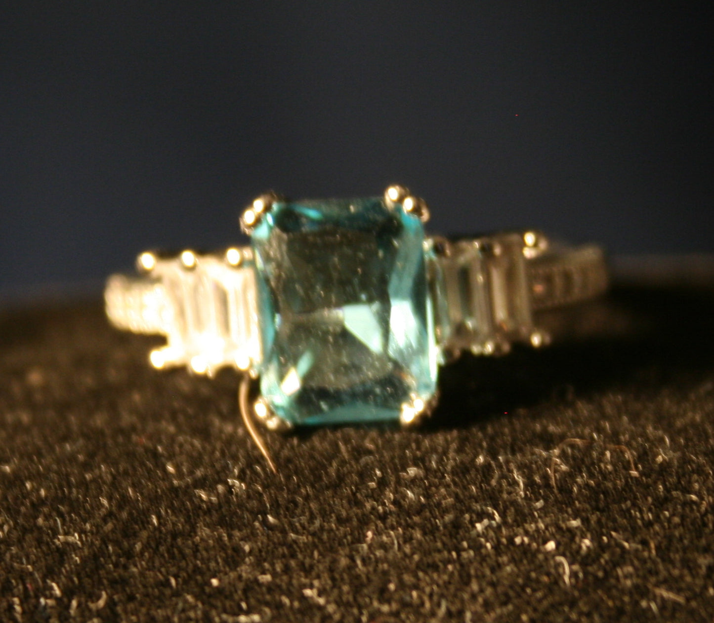 Aquamarine rectangular stone with three clear baguettes