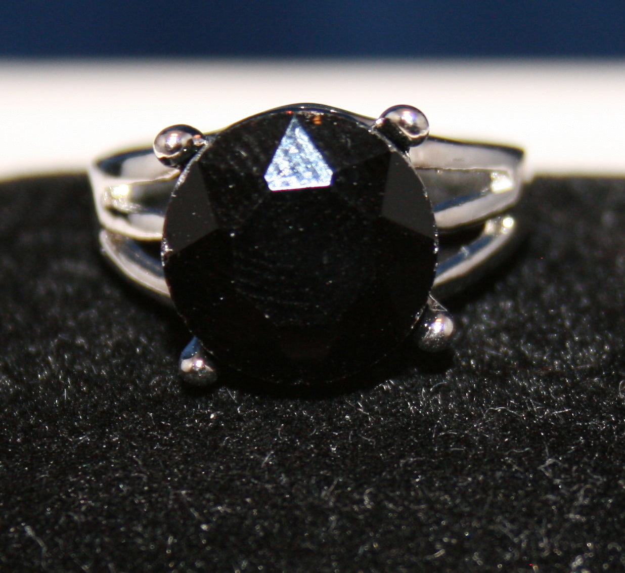 large, oval-shaped black/deep purple gemstone