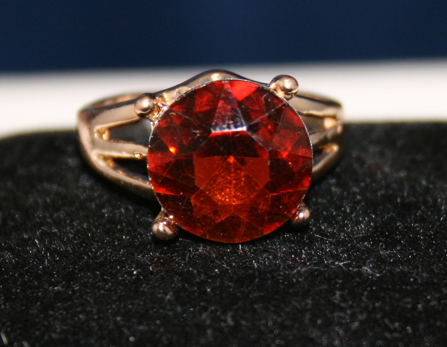 large, round, faceted red gemstone
