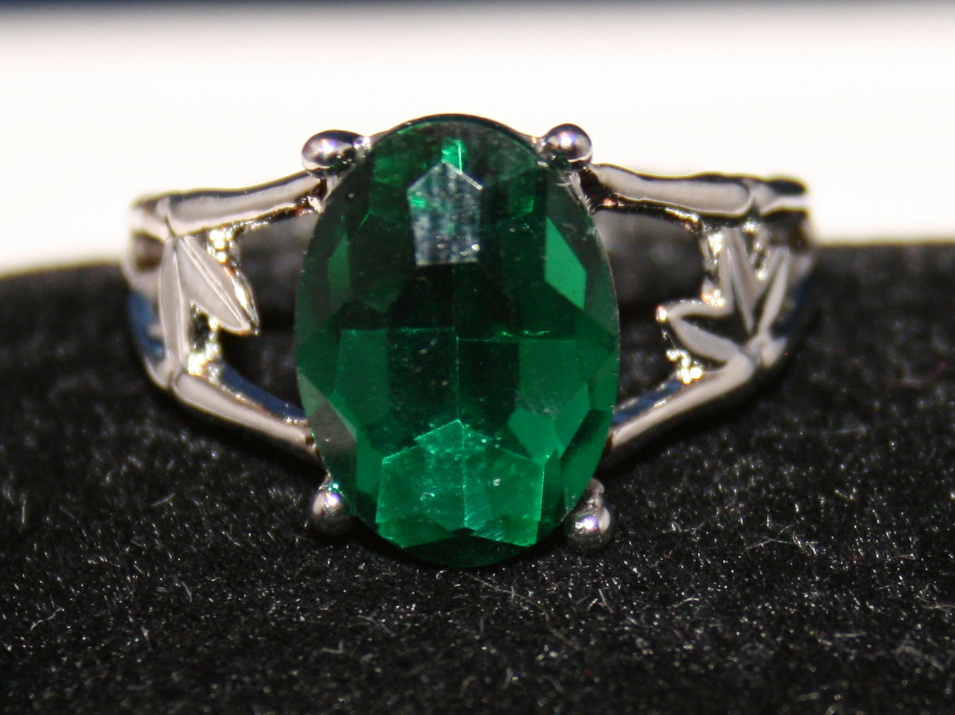 large, oval-shaped emerald green gemstone