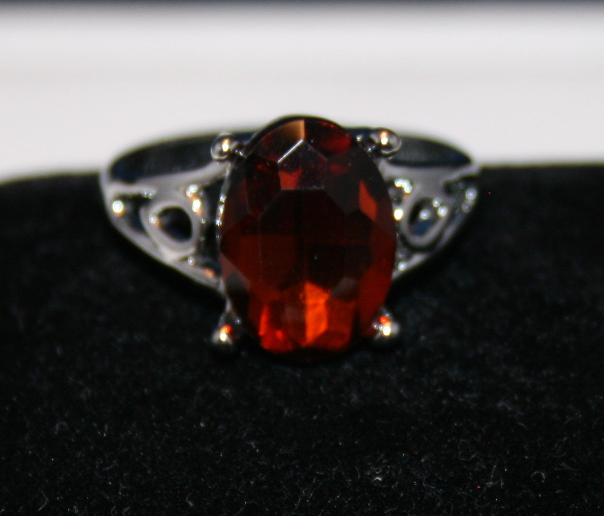 faceted reddish-orange gemstone