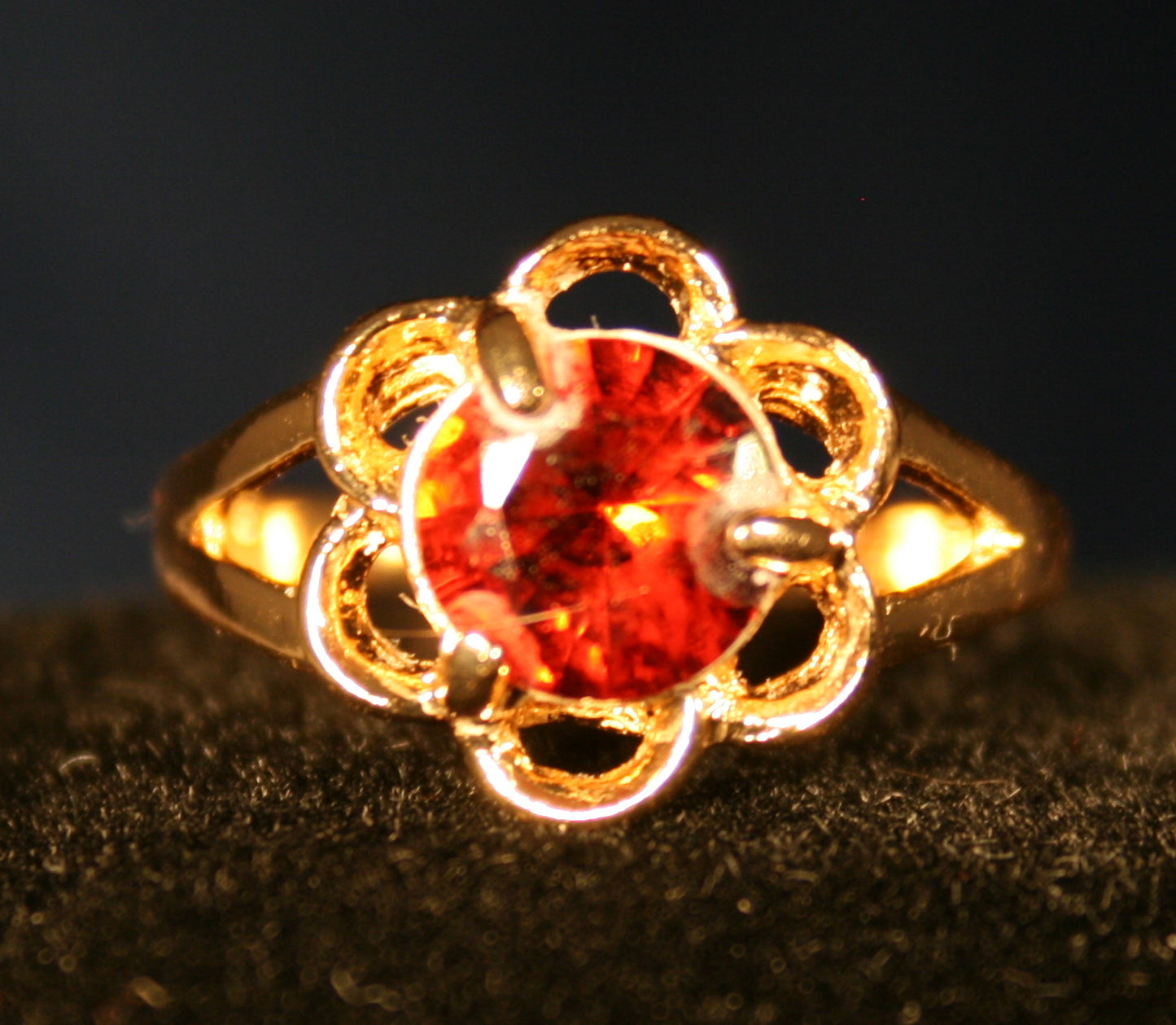 Flower setting with red gemstone