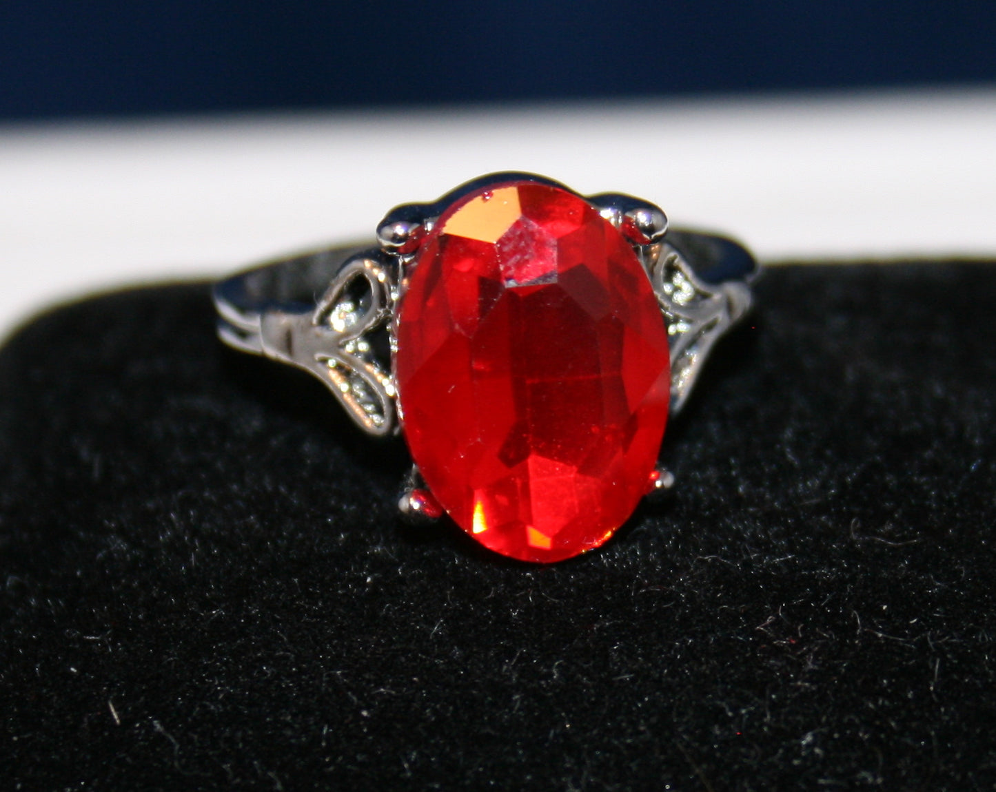 large, faceted oval vibrant red gemstone