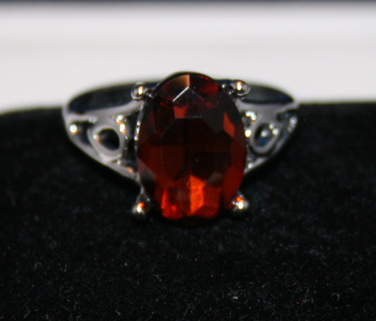 faceted reddish-orange gemstone